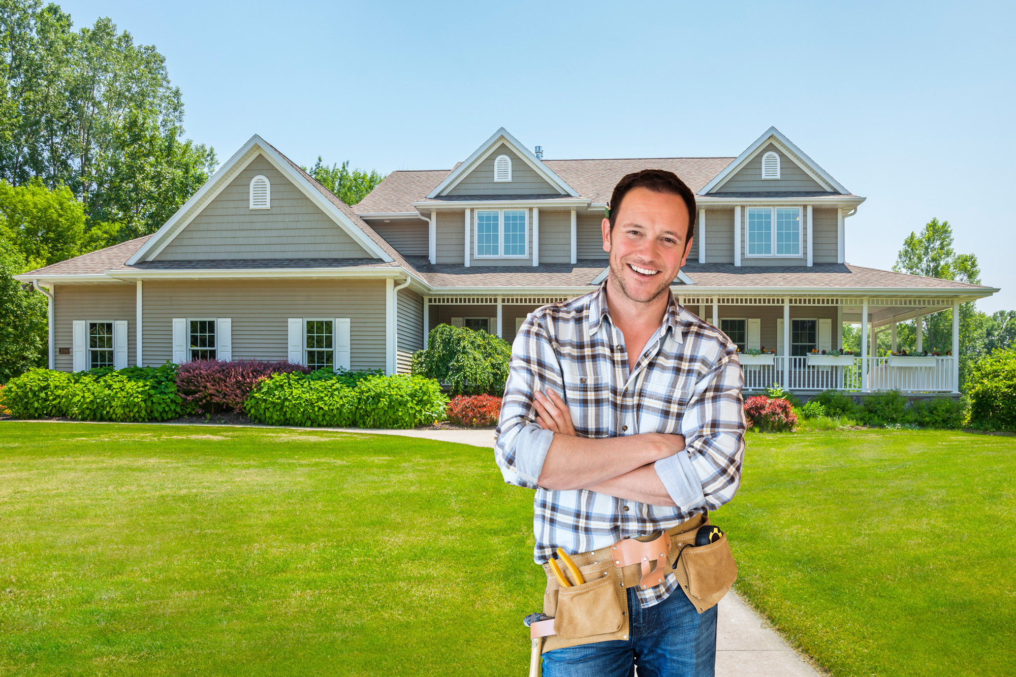 friendly contractor standing outside of a country farmhouse 